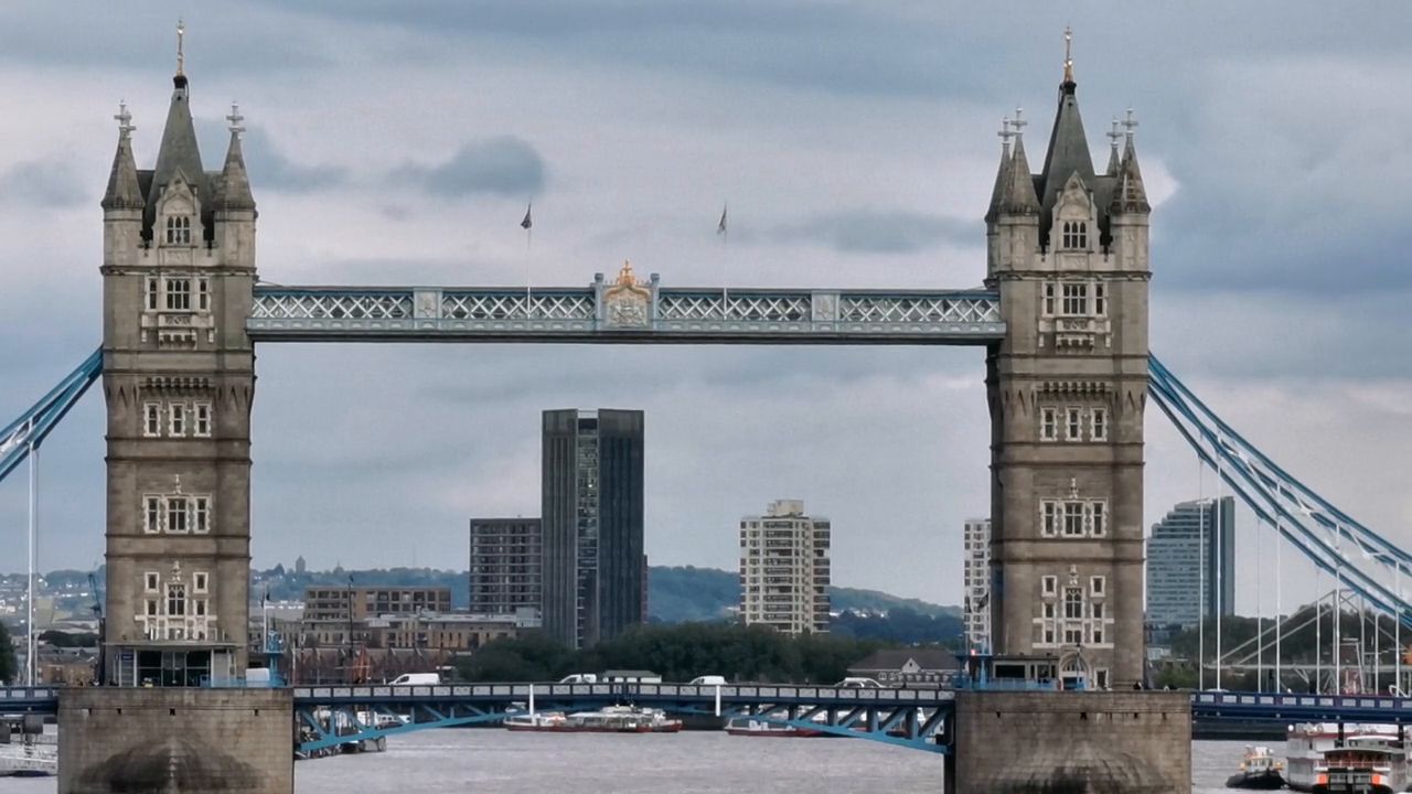 Tower Bridge seen front-on, with a tall tower block visible between its towers